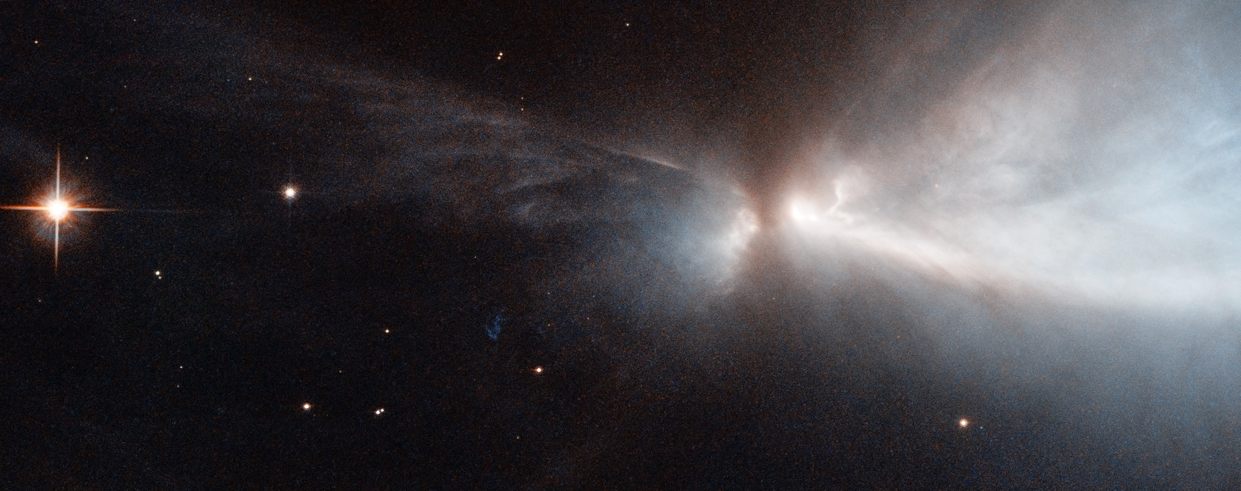 Image credit: NASA and ESA Hubble Space Telescope. Acknowledgements: Kevin Luhman (Pennsylvania State University), and Judy Schmidt, of the Chamaeleon cloud and a newly-forming star within it--HH 909A--emitting narrow streams of gas from its poles.