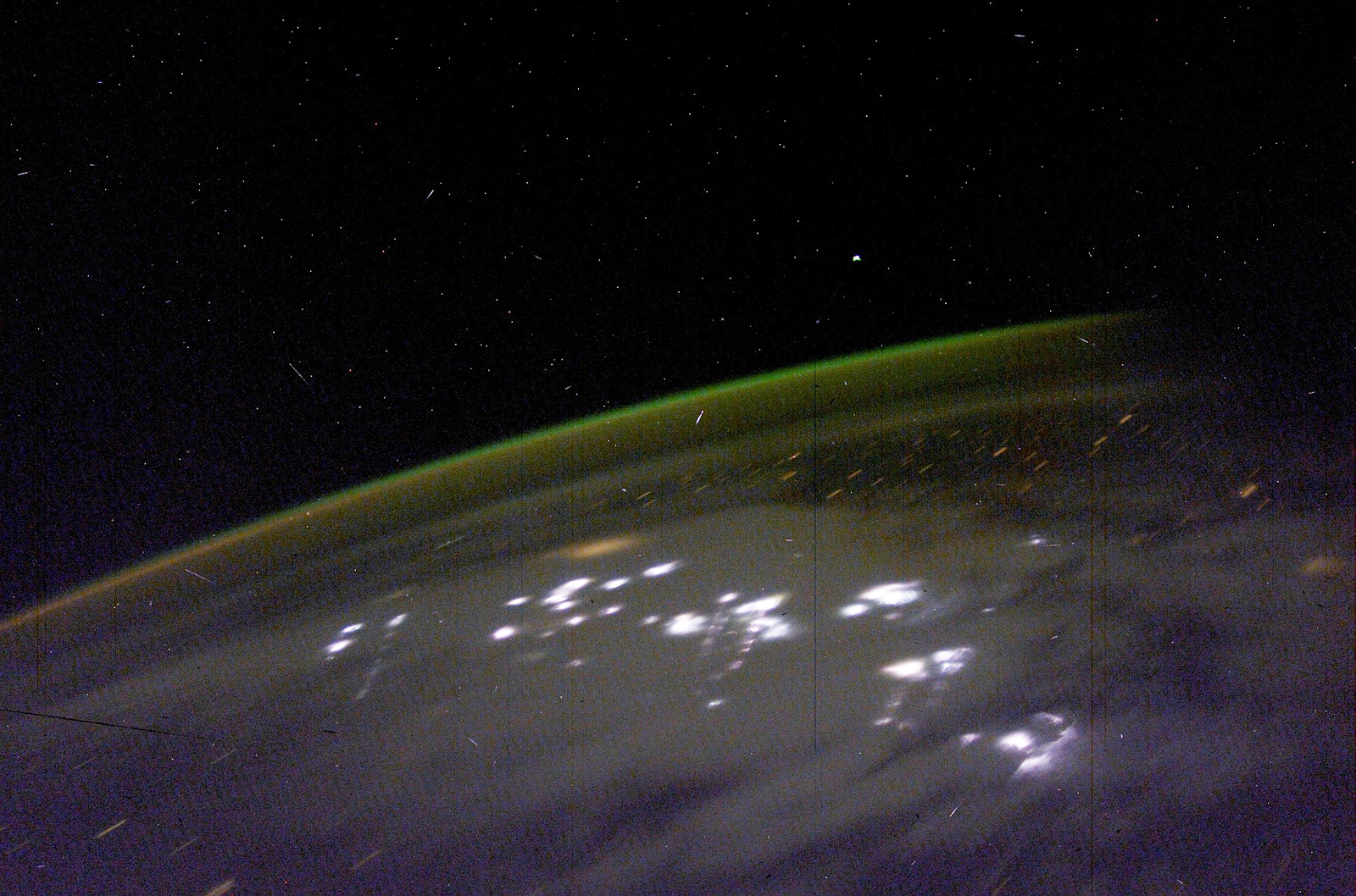 This image was taken from the International Space Station and shows the Aurora Australis and lightning.